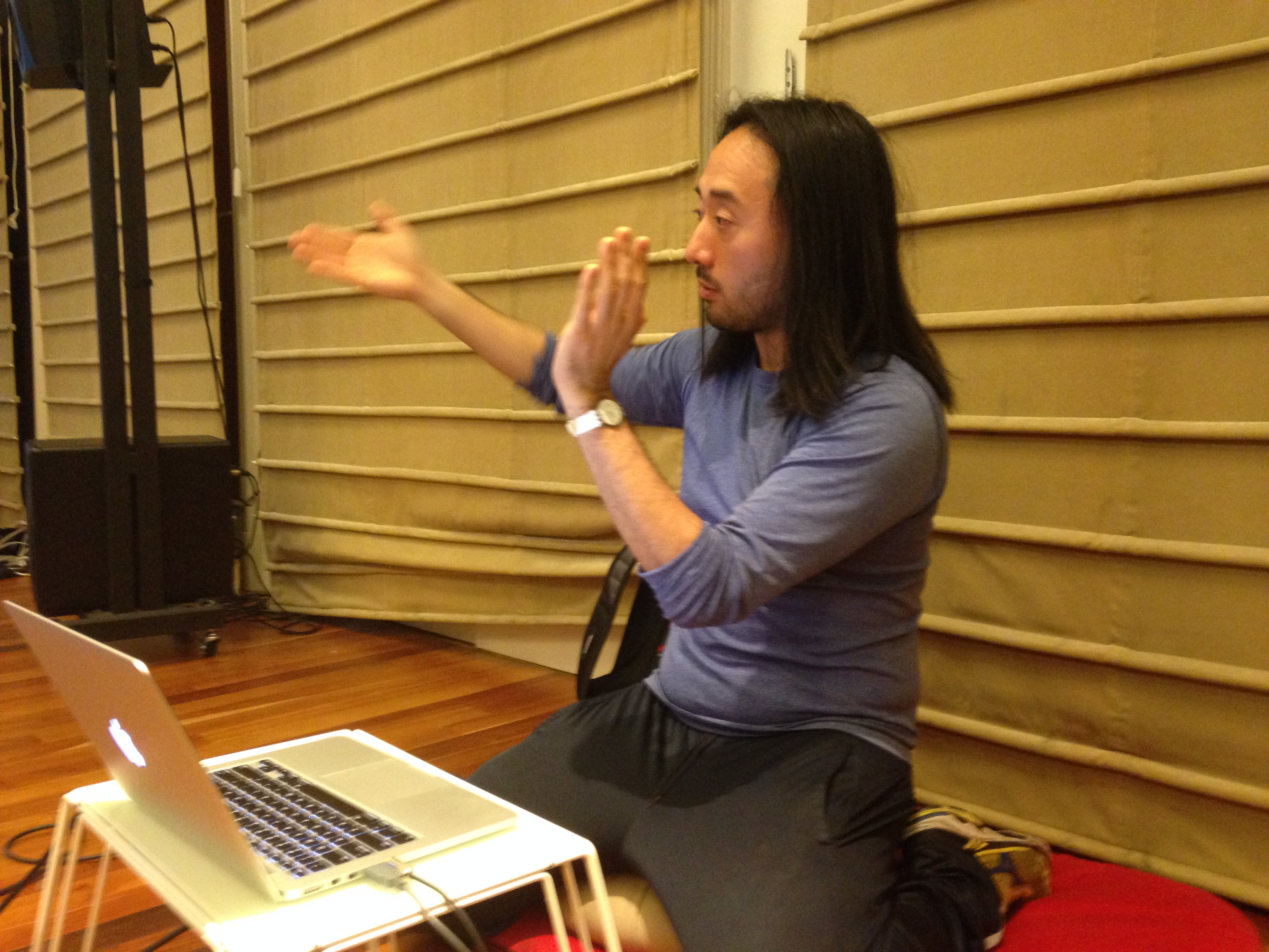 Ge Wang, assistant professor of music at Stanford's Center for Computer Research in Music and Acoustics, teaches a music coding lesson to students participating in the Stanford Laptop Orchestra.