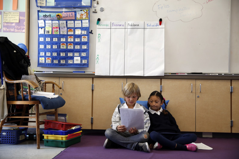 Spanish-immersion second-graders Deven Finnemore and Lia Palma read together at Monroe Elementary School in San Francisco, Calif., on Wednesday, April 29, 2015.