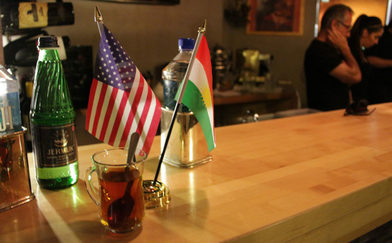 Kurdish and United States flags fly at Niroj Kurdish Cuisine’s bar.