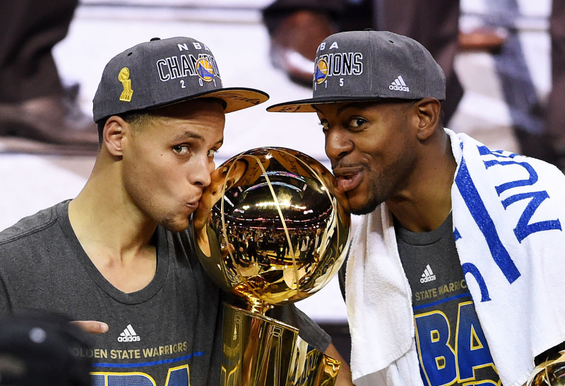 Stephen Curry and Andre Iguodala celebrate with the Larry O'Brien NBA Championship Trophy after defeating the Cleveland Cavaliers in Game Six of the 2015 NBA Finals. (Jason Miller/Getty)