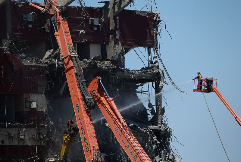 June 9: A worker sprays water on Candlestick rubble.  In January, officials changed their demolition plans after nearby residents complained that the planned implosion would send clouds of potentially toxic dust wafting through the neighborhood.