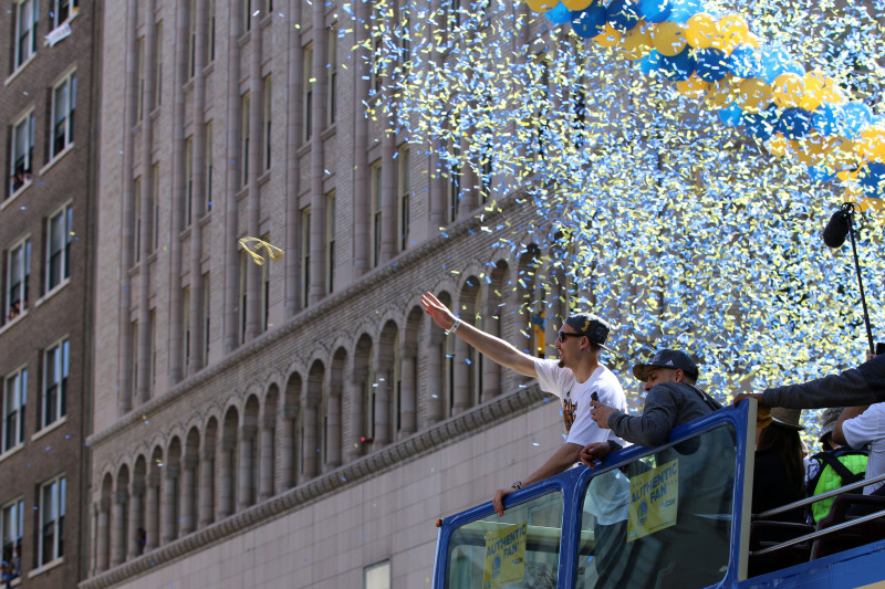 Klay Thompson throw something to the fans during the Warriors Championship parade. (Adam Grossberg/KQED)