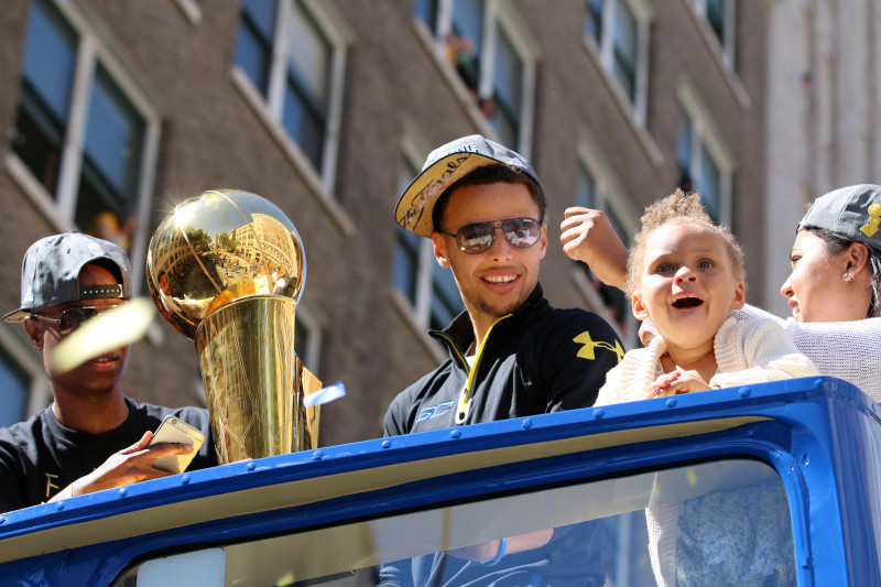 Stephen Curry and his daughter Riley celebrate during the Warriors championship parade Friday. (Adam Grossberg/KQED)