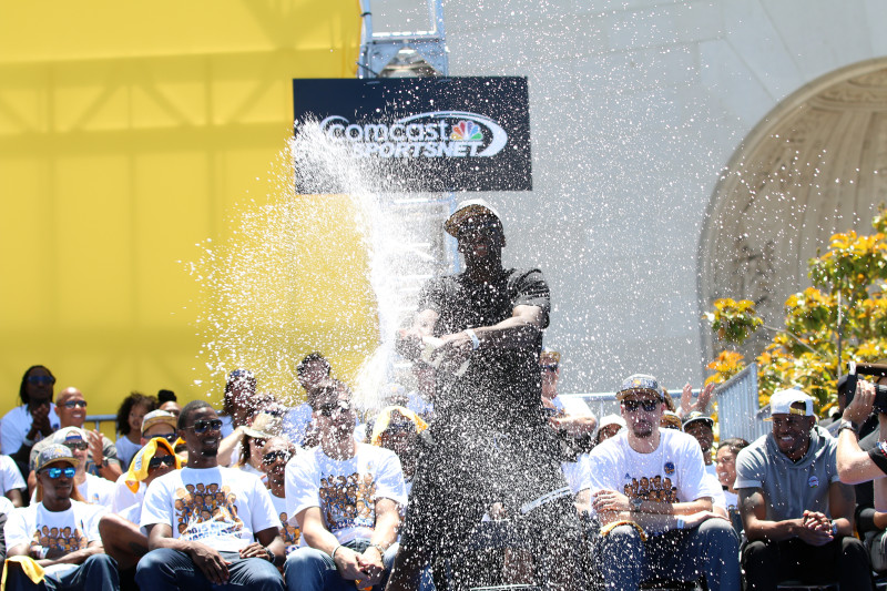Draymond Green sprays champagne at the Warriors' rally. (Adam Grossberg/KQED)