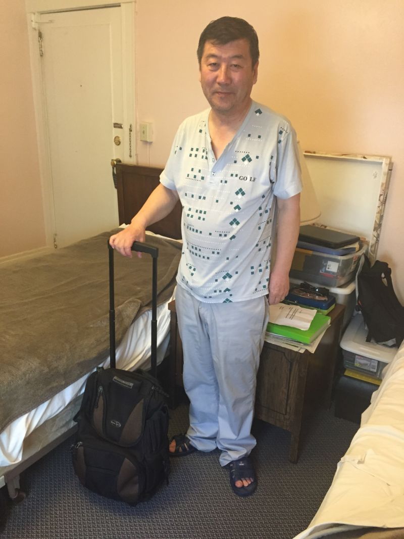 Hotel Astoria resident Paris Wang worries he will be locked out. He never leaves his room without a backpack.
