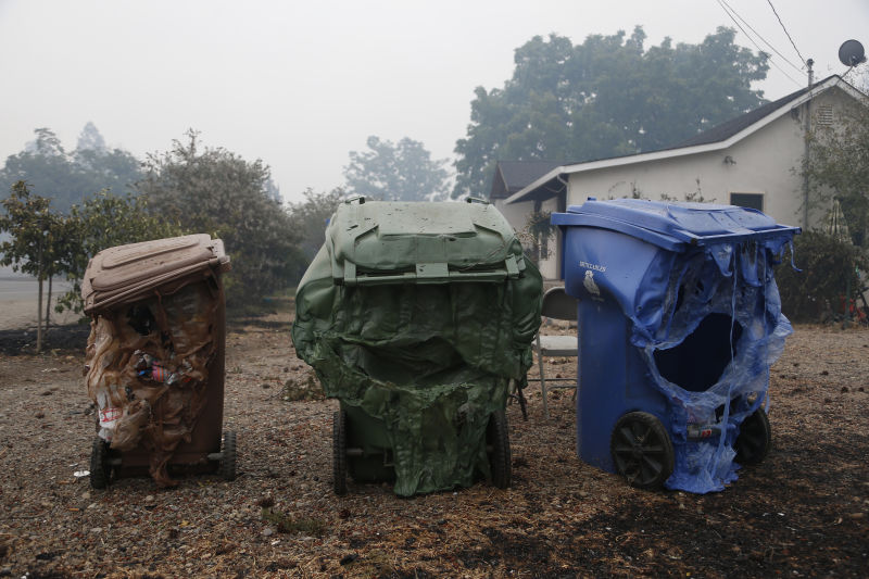 Melted garbage containers damaged by the Valley Fire sit near homes in Middletown, California. (Stephen Lam/ Getty Images)
