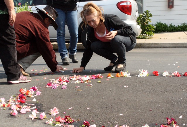 Family members and supporters of Yanira Serrano-Garcia spread flowers around the spot where she was killed near Half Moon Bay. (Alex Emslie/KQED)