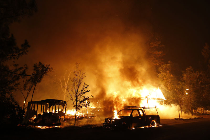 A car burns in front of a burning home during Valley Fire on September 13, 2015 (Stephen Lam/ Getty Images)