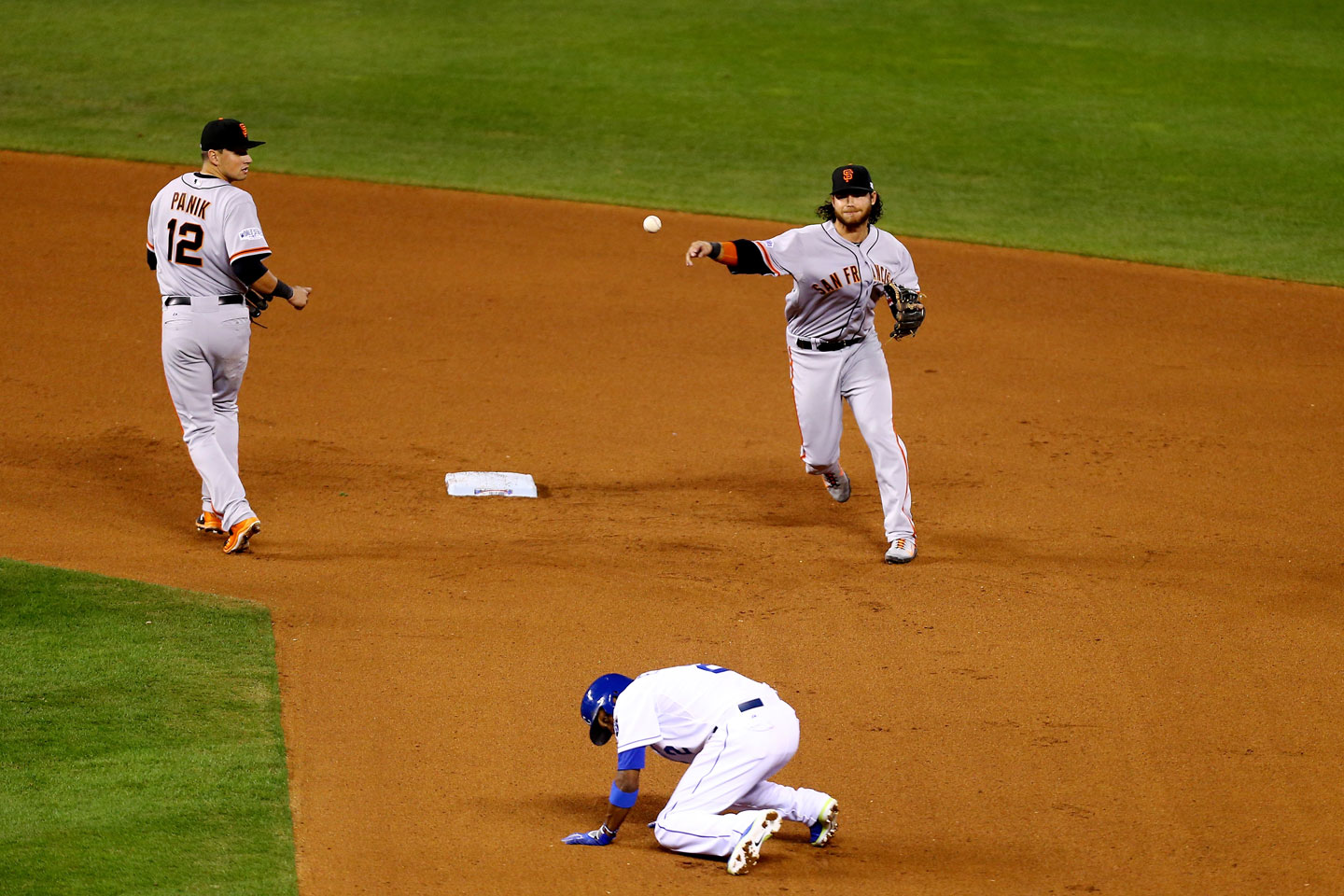 Brandon Crawford fires to first to complete a 4-6-3 double play in the eighth inning. (Ed Zurga/Getty Images)