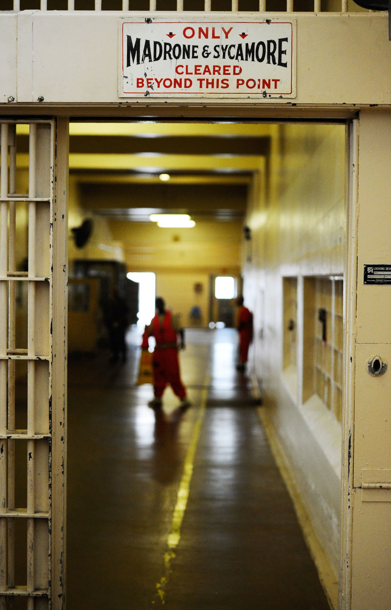 Inmates at Chino State Prison walk the hallway.