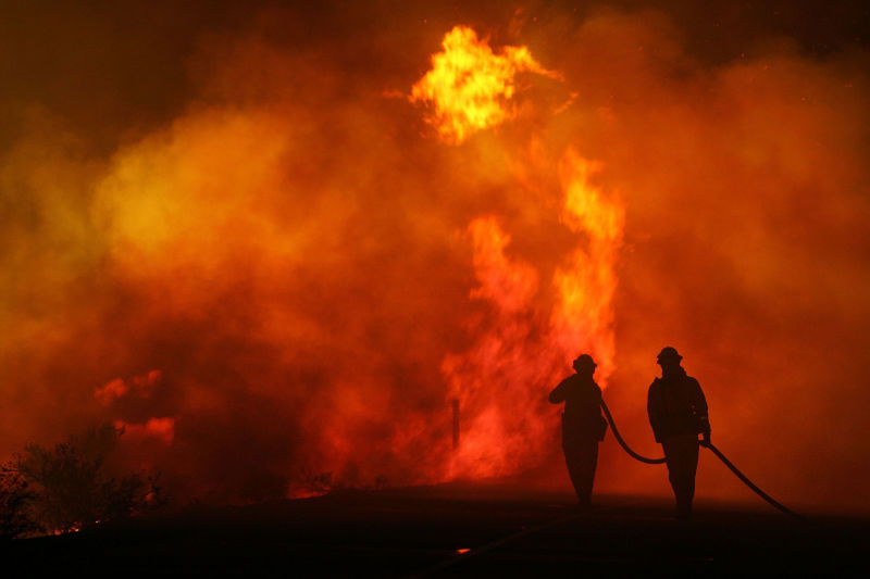Firefighters battle the deadly, wind-fed Esperanza Fire before dawn in the San Jacinto Mountains on October 27, 2006.