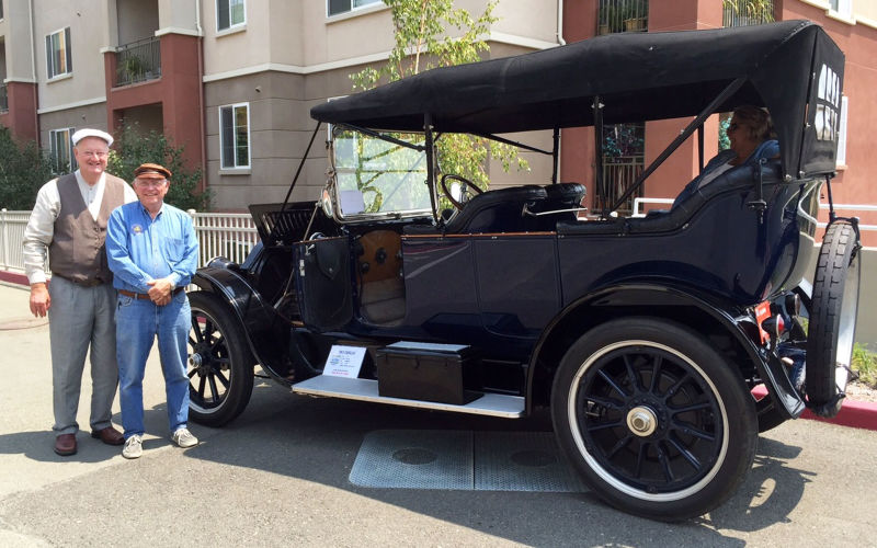 BAHCC President Eric Lundquist (L) and club member John Morrison stand next to Morrison's 103-year-old Cadillac.