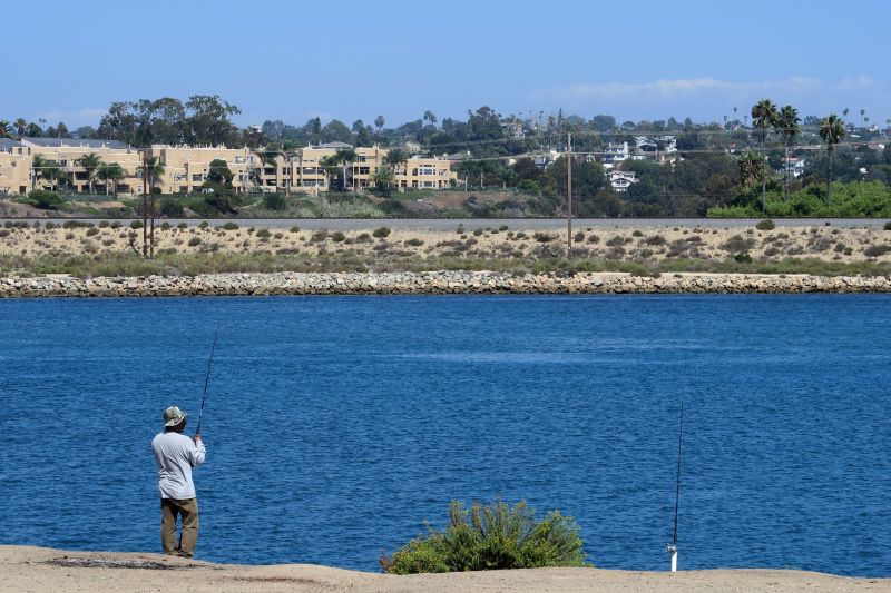 A fisherman casts his line into Agua Hedionda Lagoon, just across the shore from the Carlsbad desalination plant. The facility was designed and will be operated by Israel-based IDE Americas.