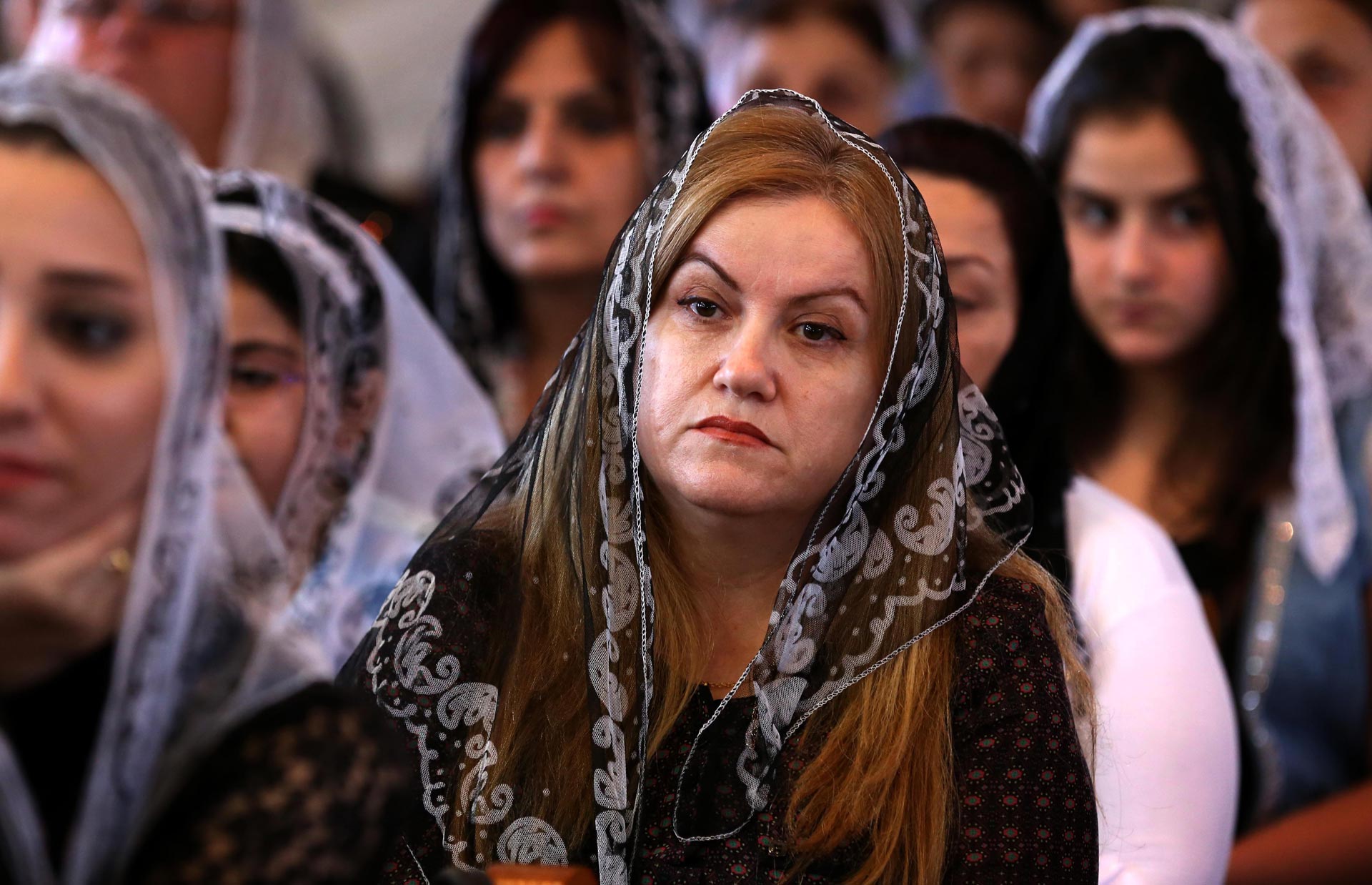 Iraqi Assyrian Christians attend a ceremony at Saint Youhanna church in Arbil, the capital of the autonomous Kurdish region of northern Iraq on September 18, 2015.