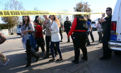 Survivors are evacuated from the scene of Wednesday's mass shooting under police and sheriff's escort in San Bernardino.