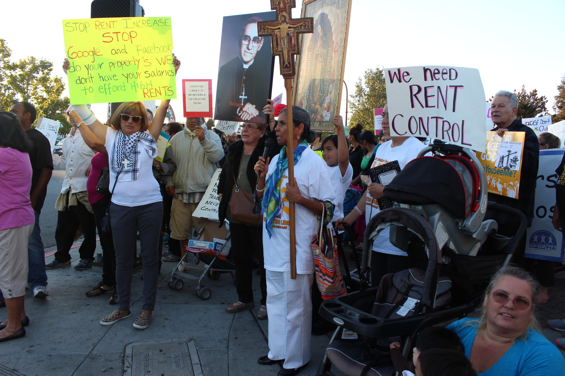 Marchers get ready to cross El Camino Real in Redwood City on October 1, 2015. They ask the City Council limits evictions and rent hikes.