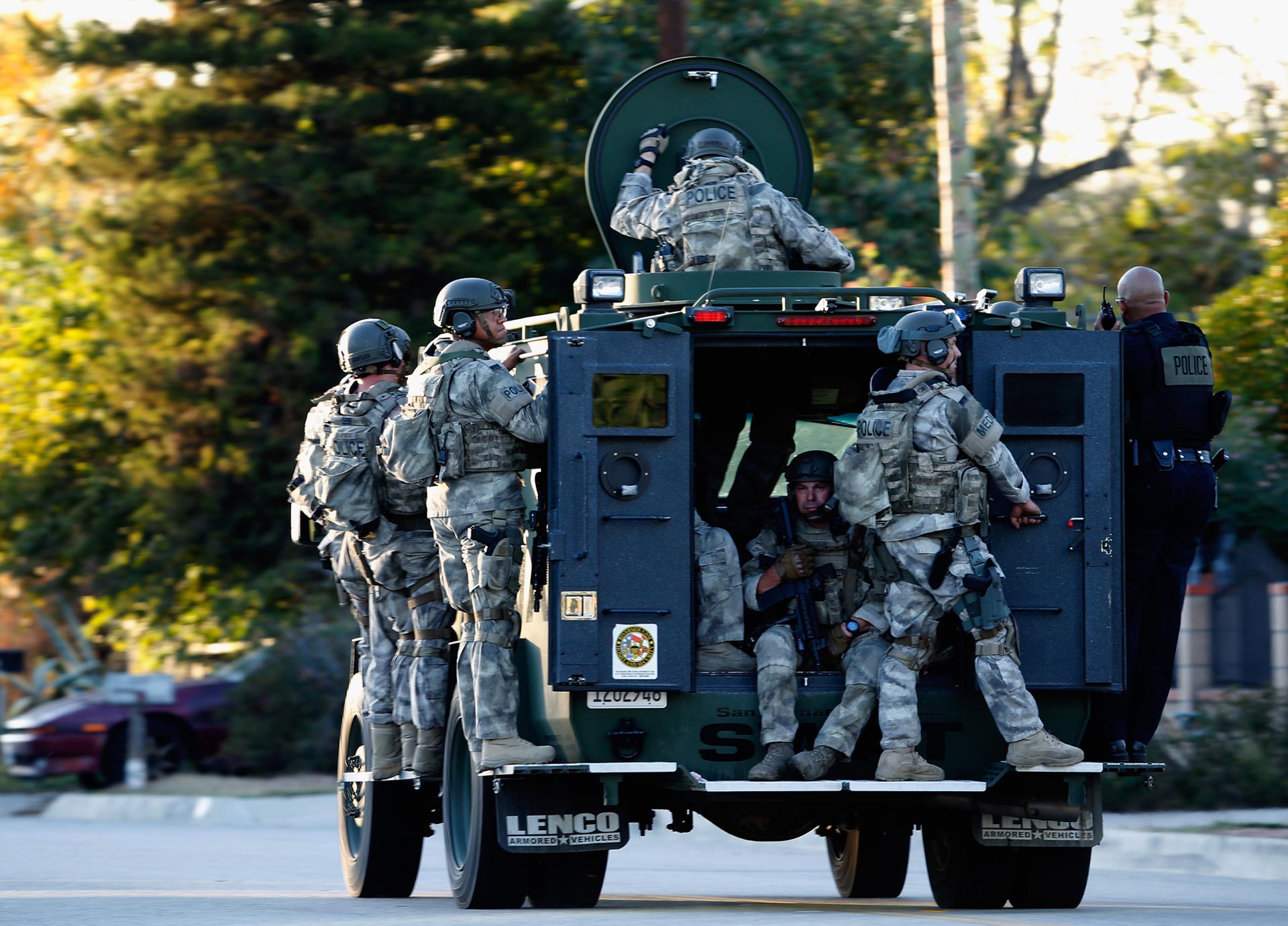SWAT officers enter a neighborhood where suspects were believed to be after the mass shooting at San Bernardino's Inland Regional Center on Dec. 2, 2015.