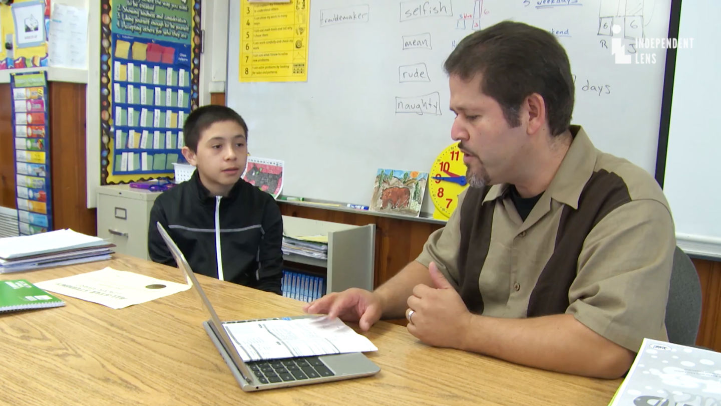 Third grade teacher Oscar Ramos works with his former student Jose Ansaldo. (Courtesy ITVS) 
