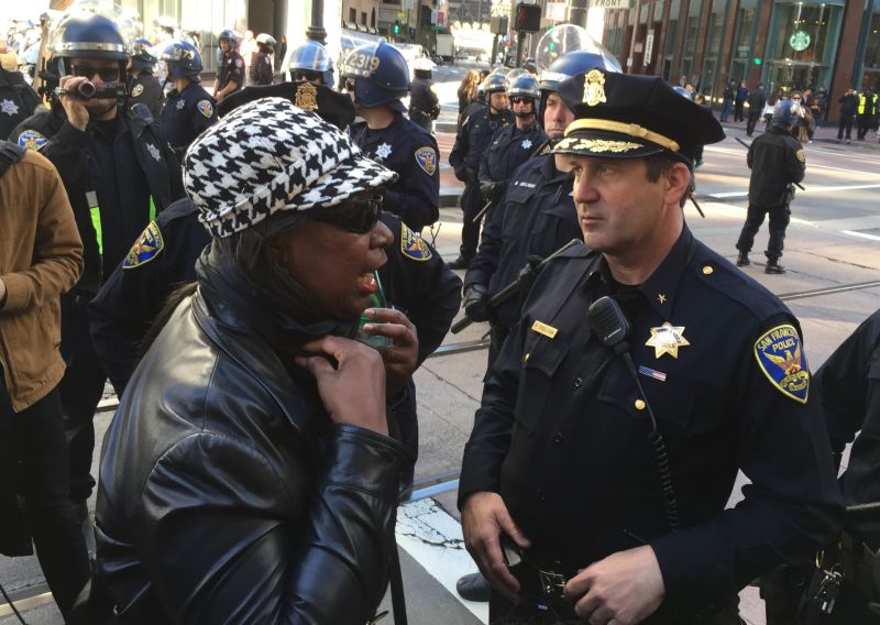 Felicia Jones with the Justice 4 Mario Woods Coalition talks to SFPD Commander Robert O'Sullivan at a police line blocking the march from the gates of 'Super Bowl City' on Jan. 30.