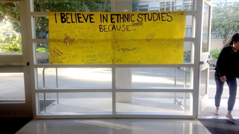 A hand-written poster that says "I believe in ethnic studies because..." is displayed at the front entrance at the College for Ethnic Studies Building at SFSU, February 24, 2016, with signatures and notes like "Don't cut my history!" written on it.