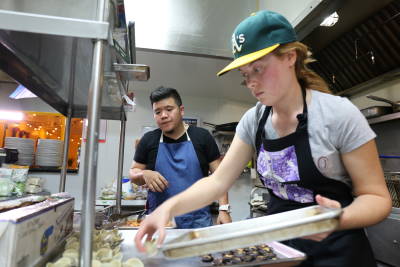 Chef Tee and Filipino Kitchen Project Manager Caitlin Preminger prepare meals for 30 guests. 