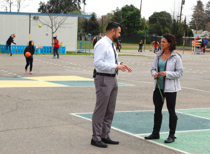 Principal Daniel Rolleri checks in with the school's behavioral specialist during recess at Oak Ridge Elementary.