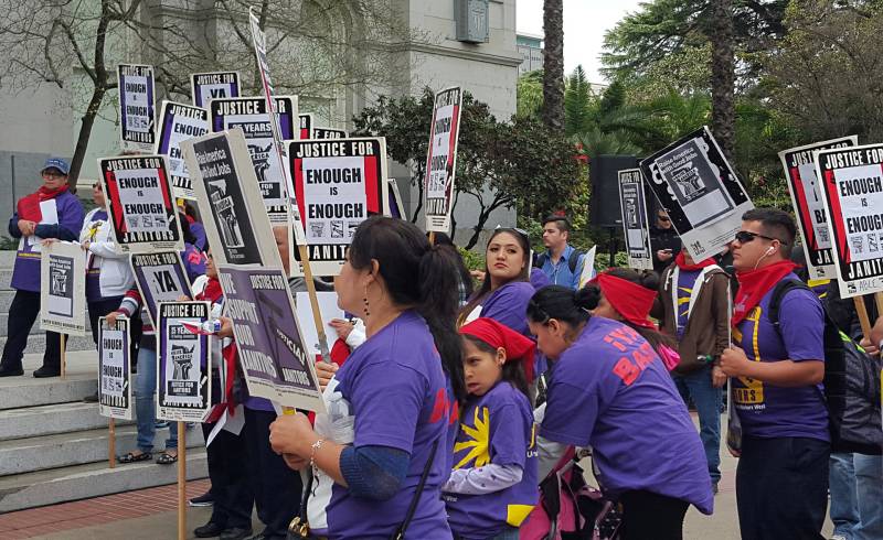 Protesters rally in support of janitors, and to bring attention to issues of sexual harassment and assault in the workplace at the state Capitol on March 8, 2016.