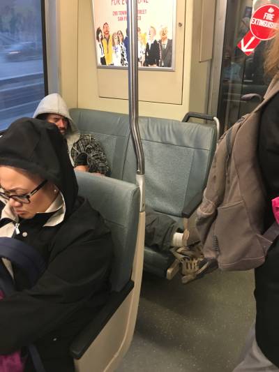 A BART seat hog enjoys a quiet moment Tuesday afternoon on Pittsbrugh-Bay Point train. Under a proposed ordinance, those who occupy more than one seat and force other passengers to stands could face a fine beginning at $100.