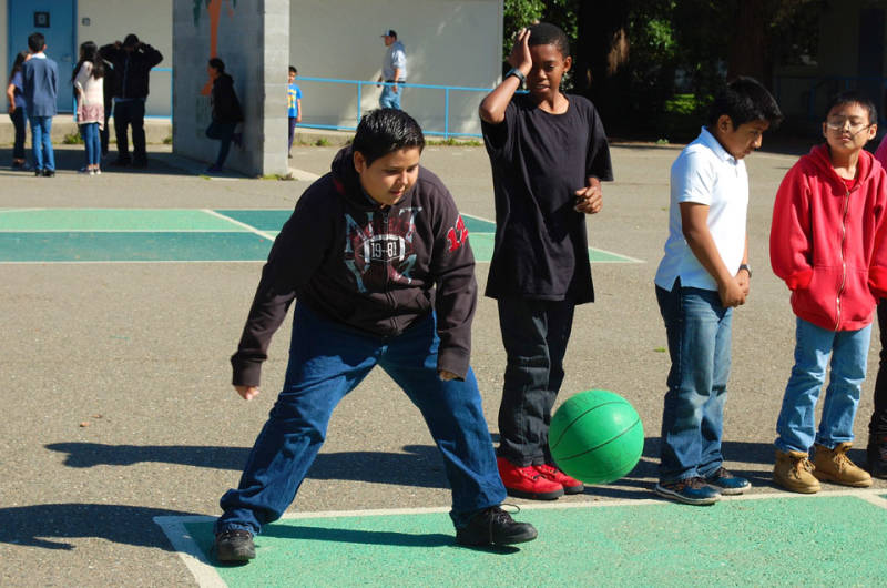 Carlos Delrio plays four square with his classmates at recess.