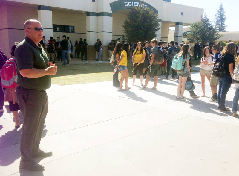 Superintendent Randy Morris greets students on the Kingsburg High campus.