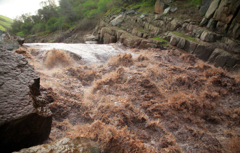 Erosion made the North Fork of the Calaveras River look like chocolate milk, after winter storms sent black ash and red clay into the waterway.