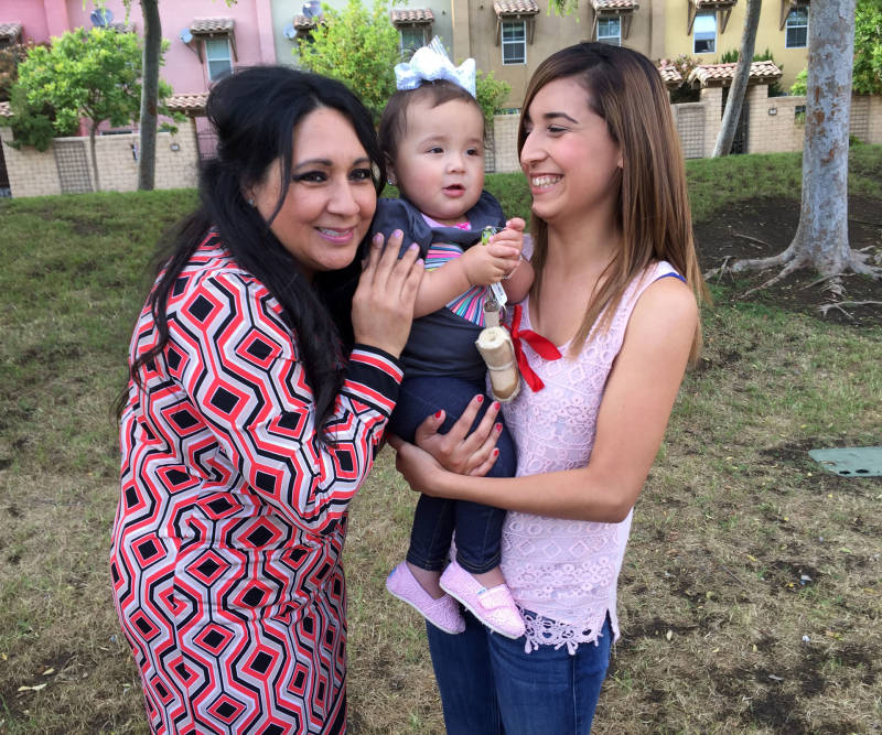 Mayor Ramona Padilla, Cassandra Baca, and her 1-year-old daughter, Amoriee.