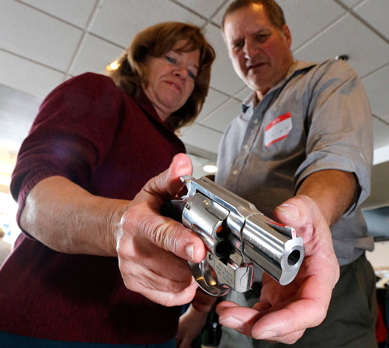 A teacher is shown how to handle a handgun at a concealed-weapons training class in Utah.