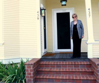 Jane Power stands in front of her home in Burbank, an unincorporated island in San Jose. 