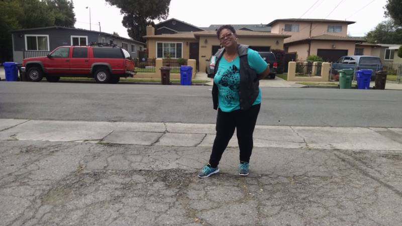 Gail Anderson and a pothole in front of her house.