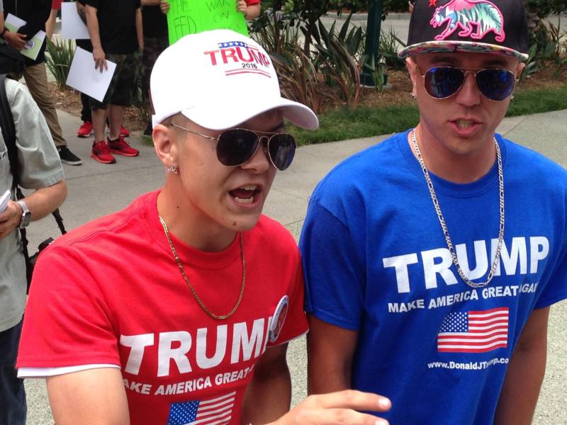 A couple of young unidentified Trump supporters face off with protesters outside the Anaheim Convention Center on Wednesday.
