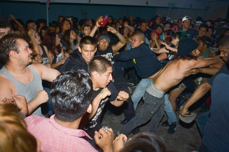 A moshpit in full force at backyard punk show somewhere in L.A. 