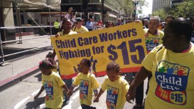 Child Care workers and their supporters march through downtown Oakland as part of a "Fight for 15" demonstration on April 14, 2016.