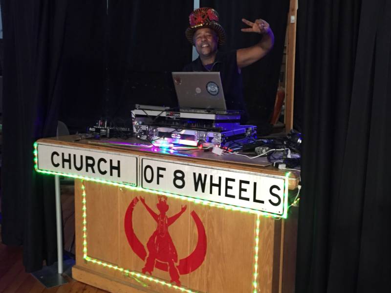 David G. Miles, Jr. created the Church of 8 Wheels. In addition to skating, the "Godfather of Skate" sometimes mans the DJ booth.