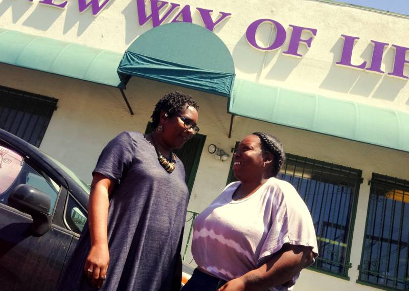A New Way of Life associate director Tiffany Johnson (L) with resident and organizer Ingrid Archie outside the organization’s Compton area headquarters. 
