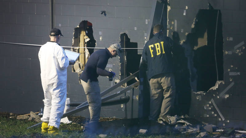 FBI agents inspect the rear wall of the Pulse Orlando nightclub in Orlando, Fla., where authorities say 49 victims died Sunday. The gunman, identified as Omar Mateen, was killed by police.