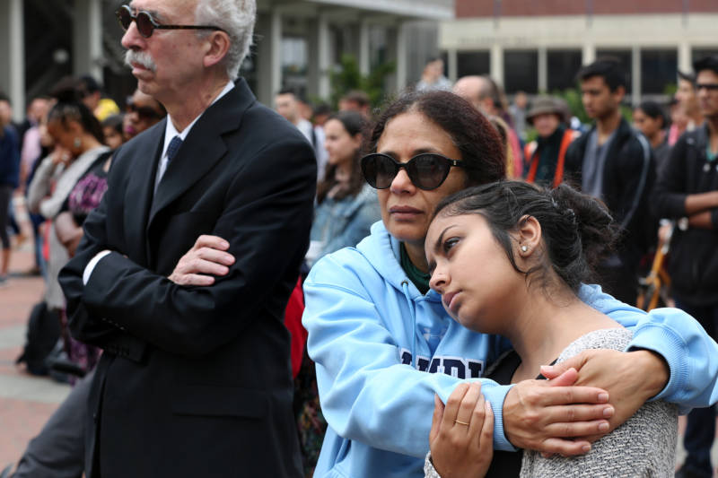 A young student is consoled during a vigil for 19-year-old UC Berkeley student Tarishi Jain, one of the victims of an attack at a Dhaka cafe in Bangladesh on July 2,2016. The vigil was held on UC Berkeley's campus in Berkeley, Calif. on July 5, 2016.