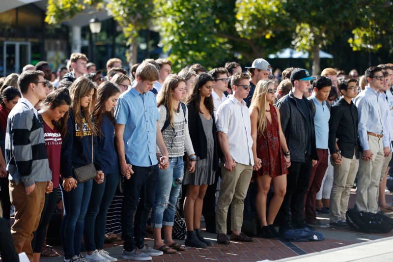 Mourners hold hands during a vigil in honor of Nicolas Leslie, a UC Berkeley student killed in last week's truck attack in Nice, France, on July 18, 2016.