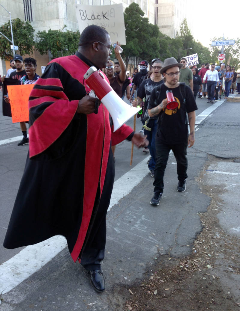 Rev. Floyd Harris leads a crowd to Fresno City Hall, asking the mayor to speak out against police brutality.