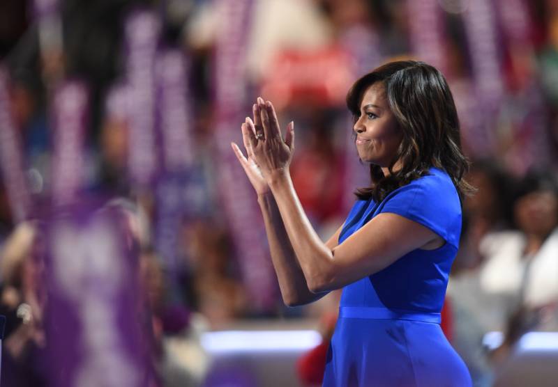 First Lady Michelle Obama applauds from the stage after addressing delegates on the first day of the Democratic National Convention in Philadelphia.