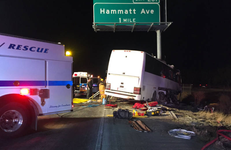 The charter bus struck a highway sign, which sheared it nearly in half.