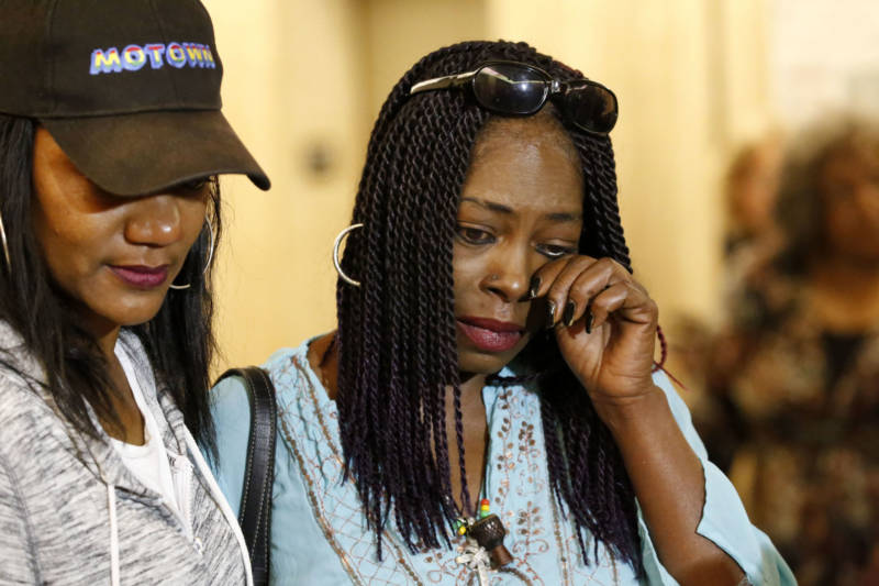 Kenneitha Lowe (R), sister of 'Grim Sleeper' victim Mary Lowe, wipes a tear in a downtown Los Angeles courtroom on June 6, 2016. At left is Tracy Williams, cousin of victim.