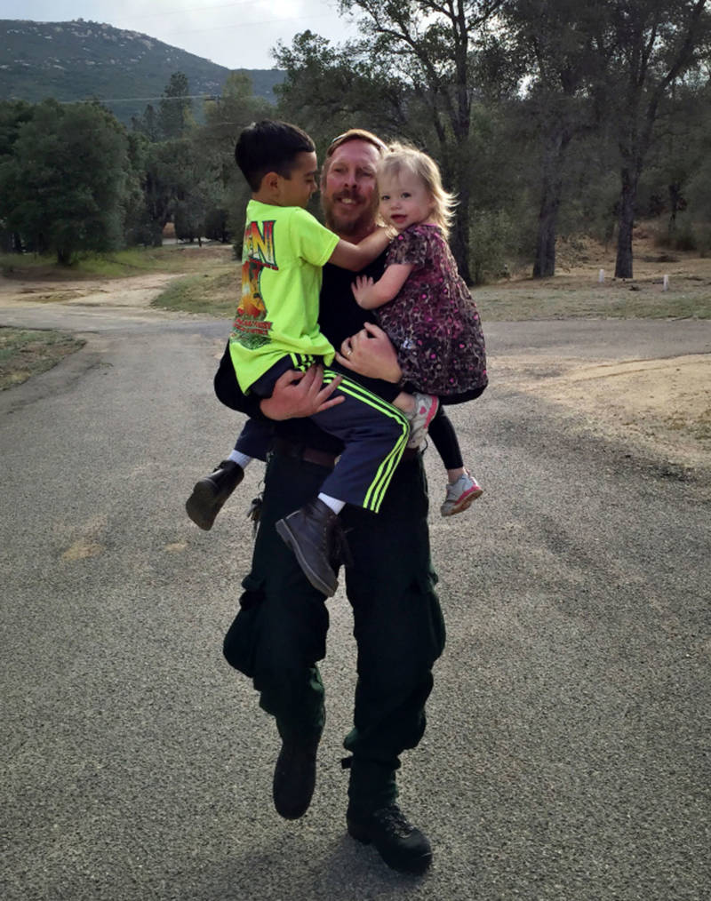 Jim Huston, superintendent of Laguna Interagency Hotshot Crew with the U.S. Forest Service, grabs his children Thomas, 7, and Hannah, 3. Hotshot crews can spend weeks at a time away from their families.