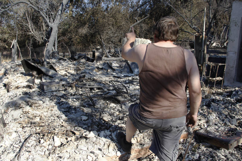 Michael Skidmore points out where certain rooms use to be in his family’s home before the Clayton fire in Lower Lake, California destroyed it.