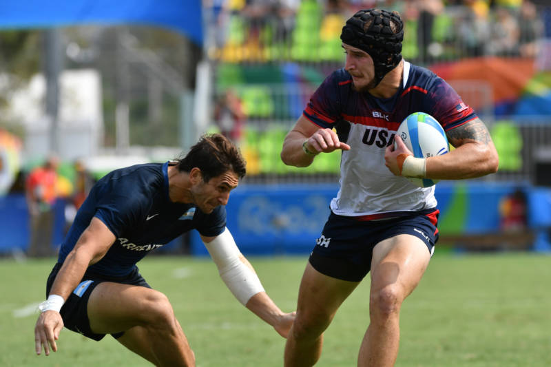 USA's Garrett Bender (R) runs with the ball in the men's rugby sevens match against Argentina during the Rio 2016 Olympic Games on Tuesday.